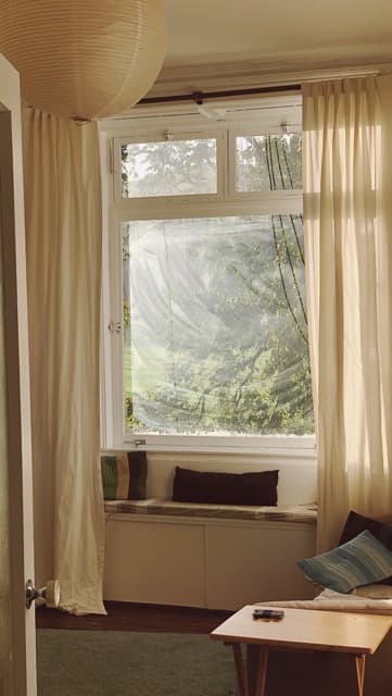 Warm morning light through bay window in European apartment