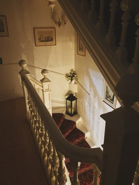 Elegant curved staircase with warm lighting in historic European building