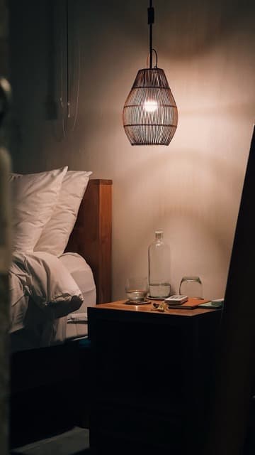 Intimate bedside lighting and curated details in boutique accommodation